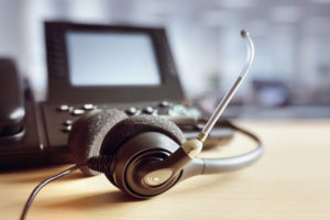 Headset headphones and telephone in an office.