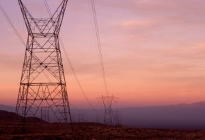 Electrical towers standing at sunset.